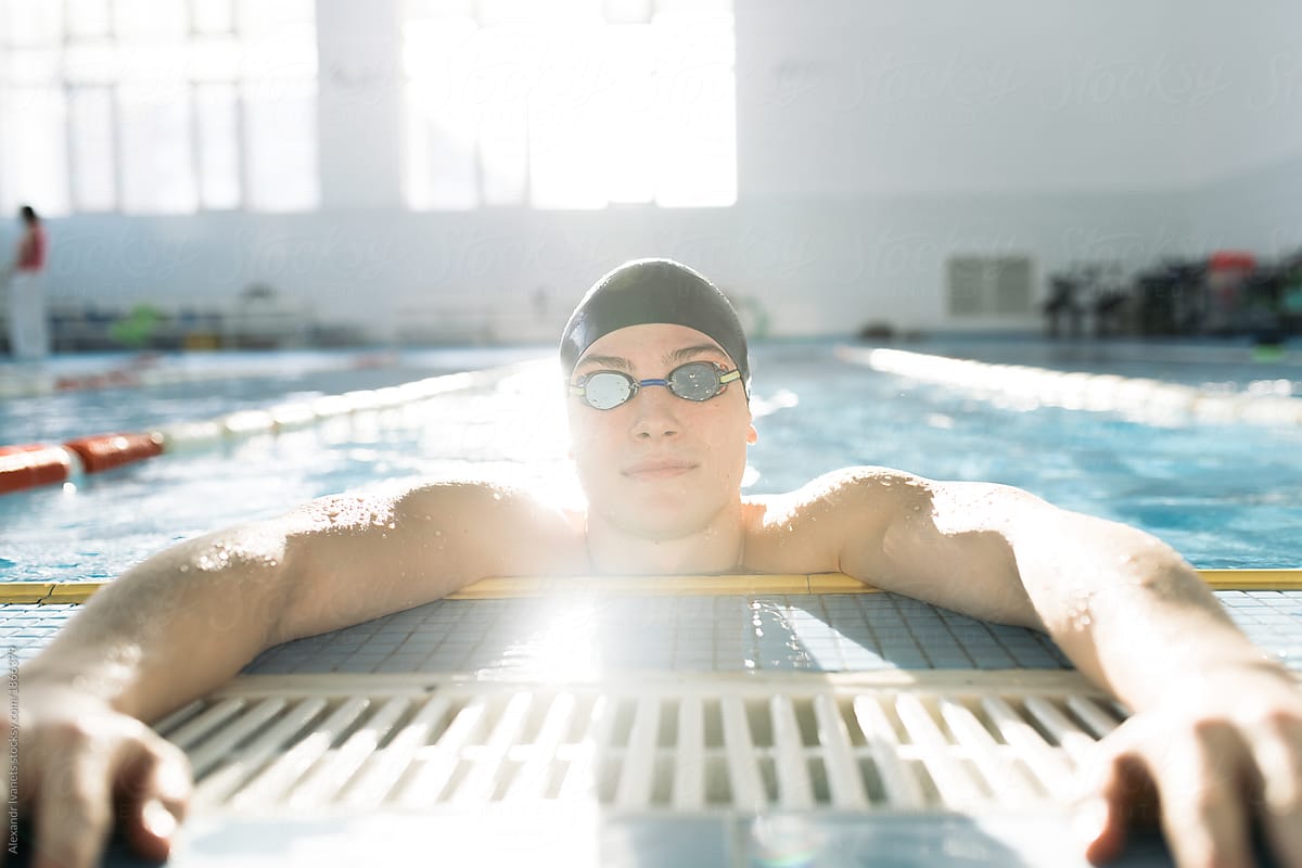 Swimmer in pool looking at camera