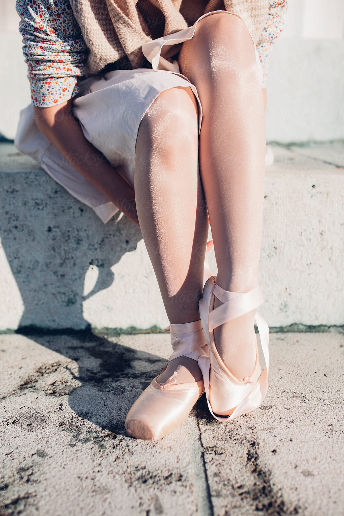 Ballerina putting on her ballet shoes