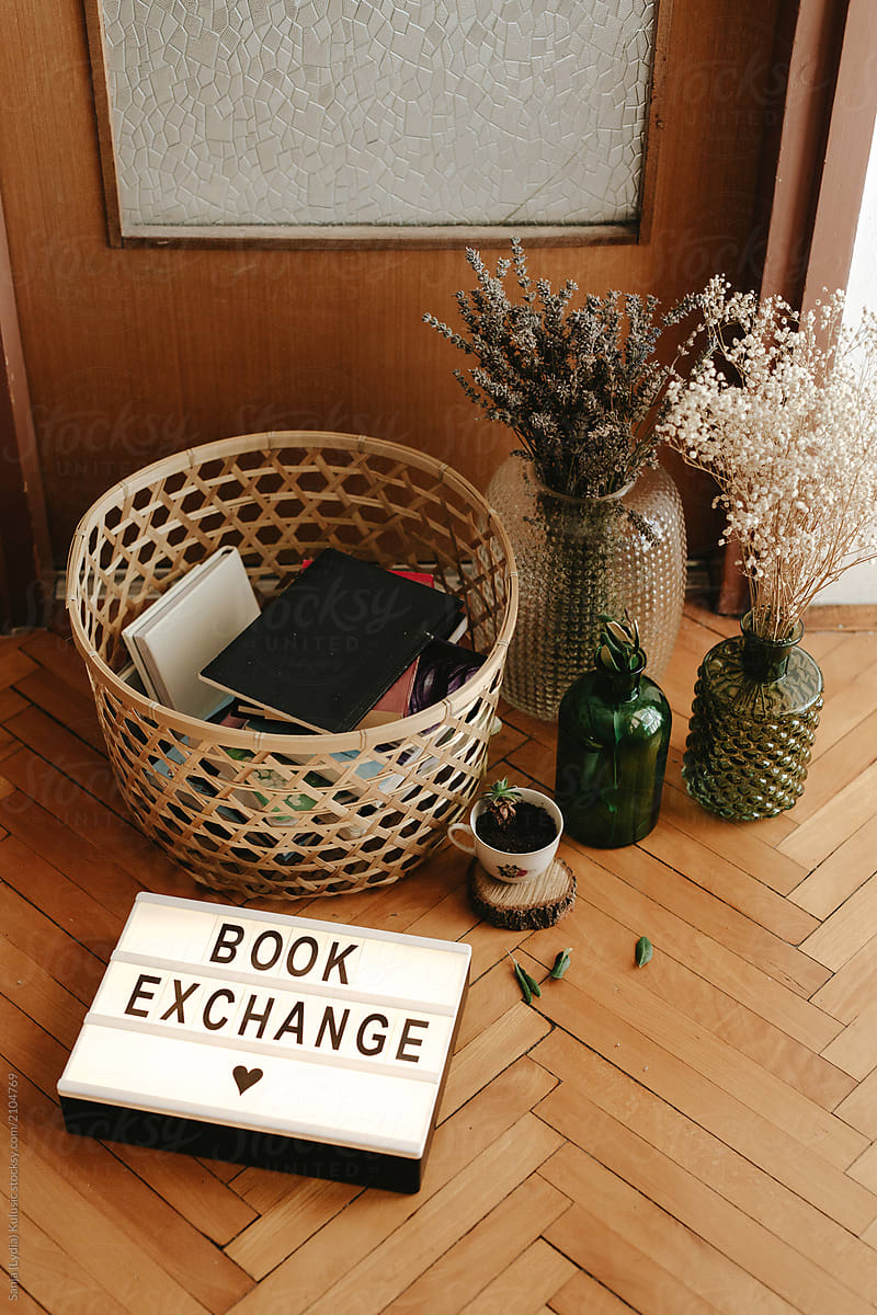 Book exchange light sign with lot of books in the basket