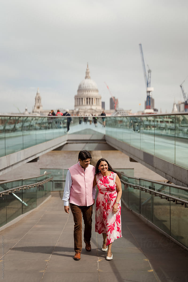 Adult couple walking on a bridge in London