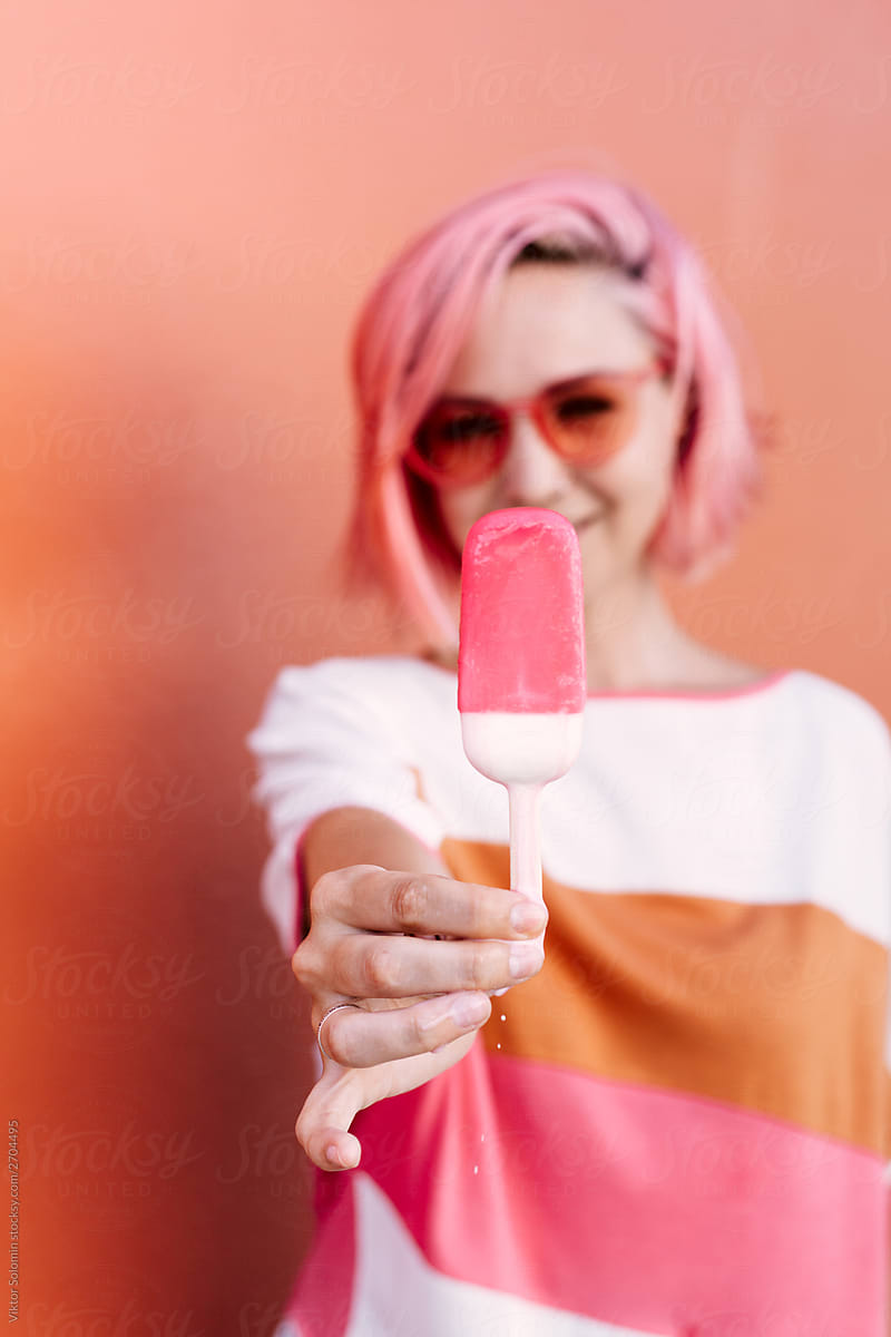 Summer colorful closeup portrait of young woman with pink hair. Vivid colors style.