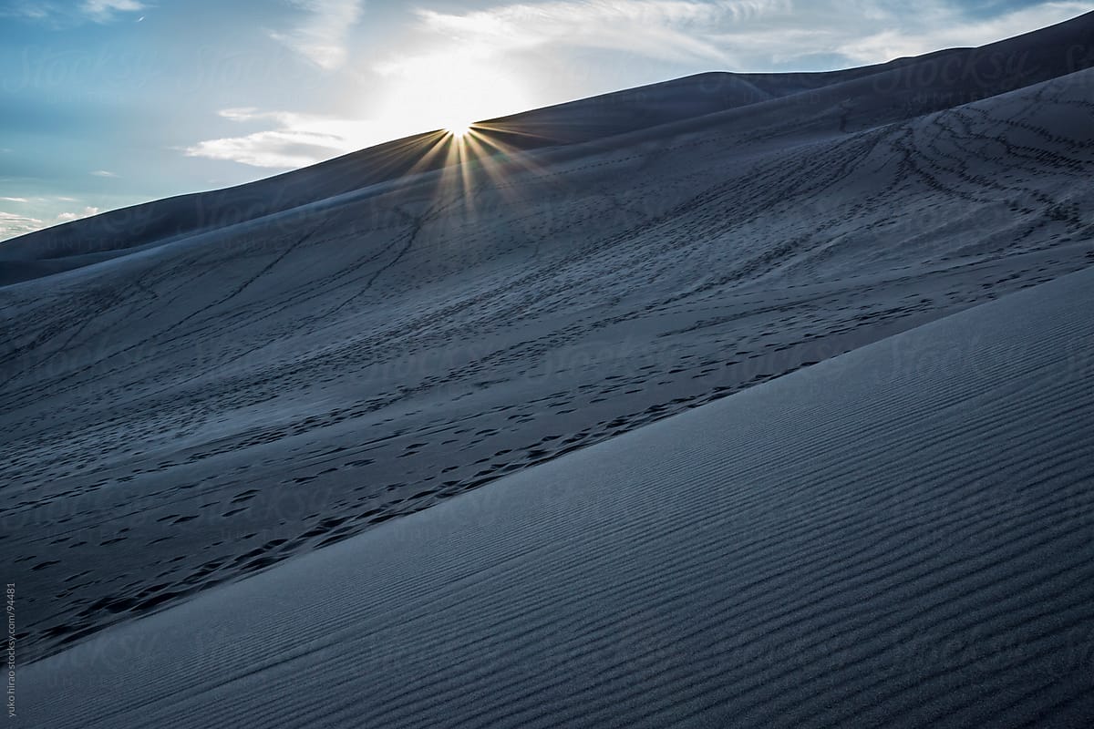 Dramatic sunset over sand dunes at desert