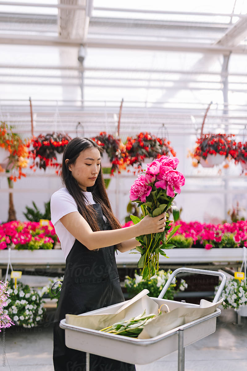 Floral employee creating composition of flowers