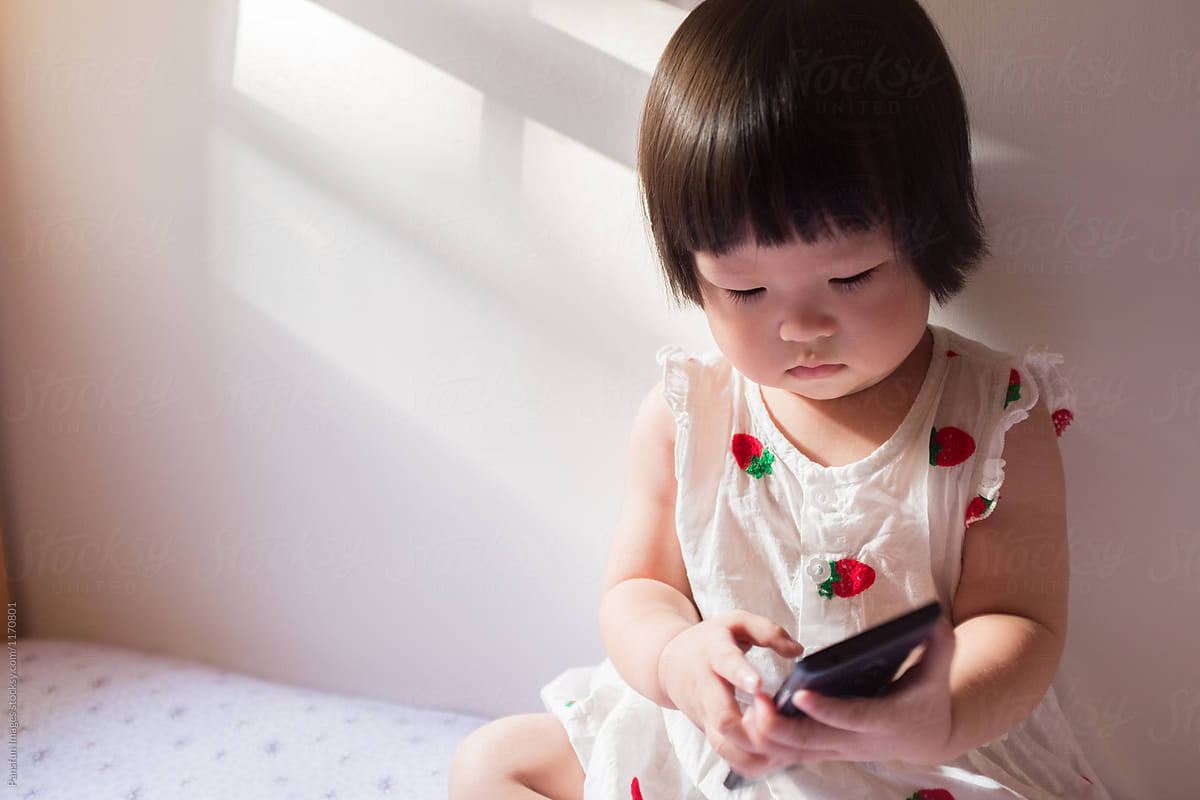 chinese baby girl using cell phone