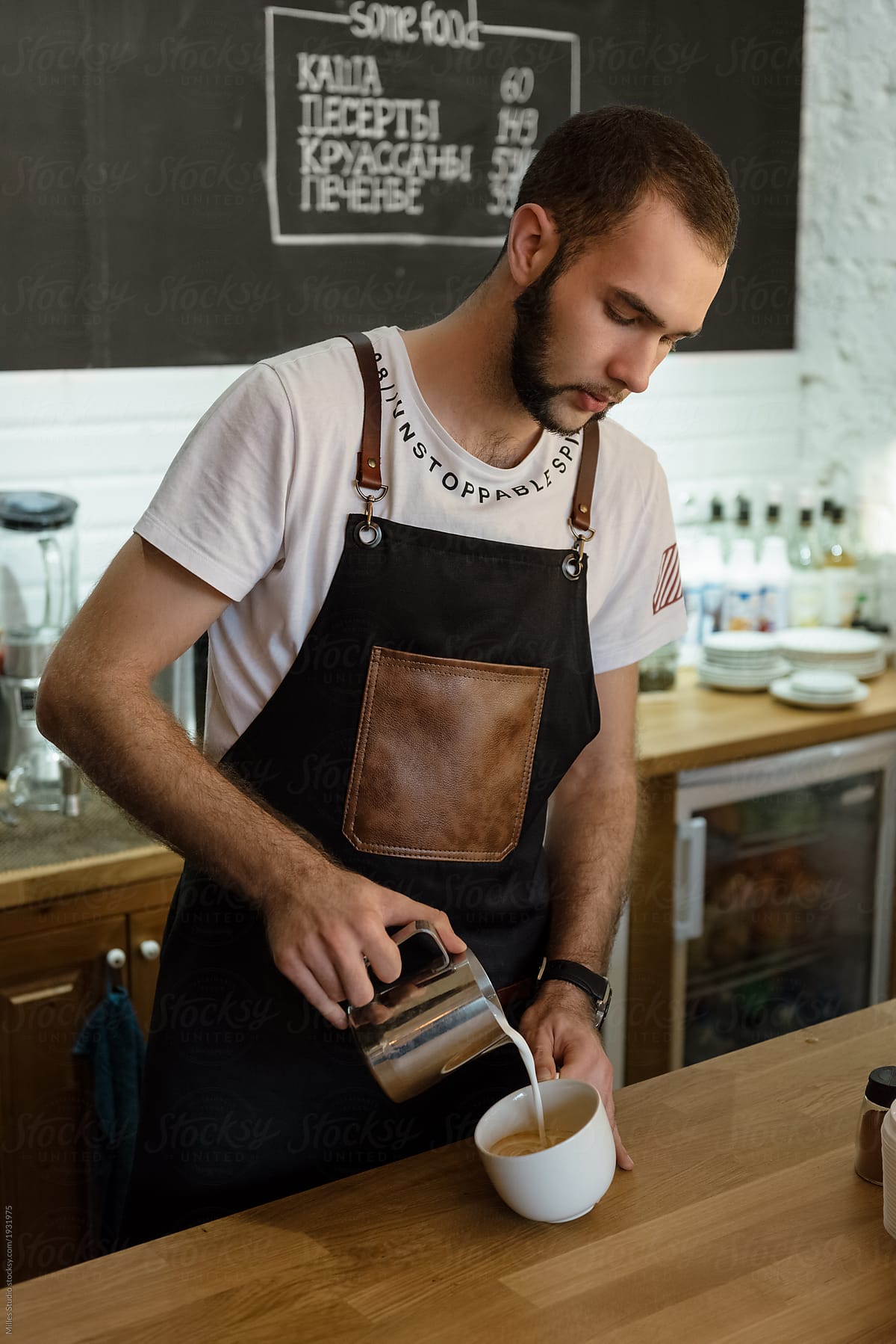Man preparing coffee at counter