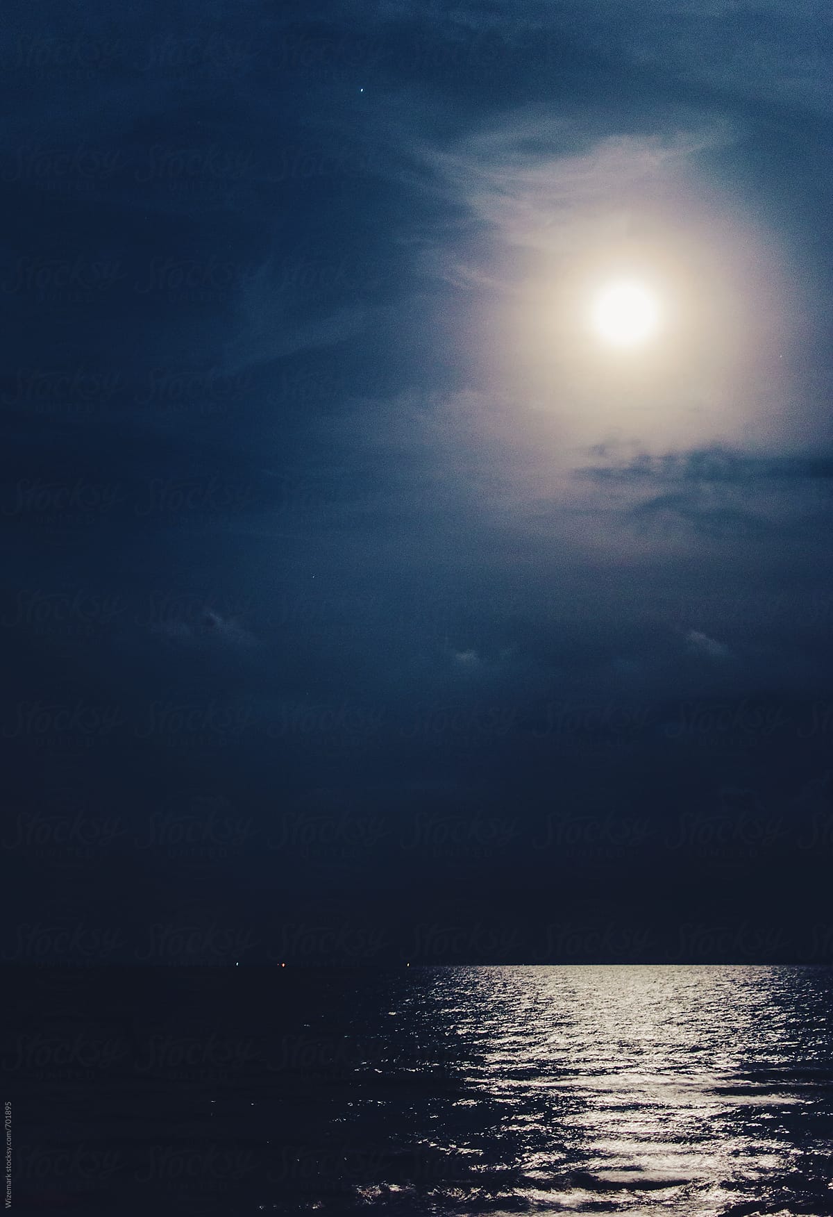 Full moon with the reflected light on the sea surface background