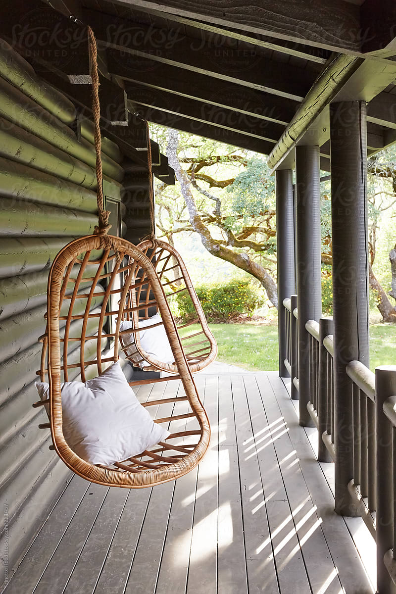 Swing Chairs On Porch Of Modern Design Log Cabin By Trinette Reed 