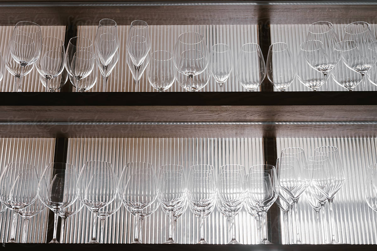 Rows of glasses on shelves in restaurant