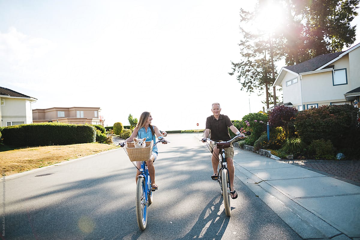 Healthy, active couple enjoying life riding cruiser bikes in sun