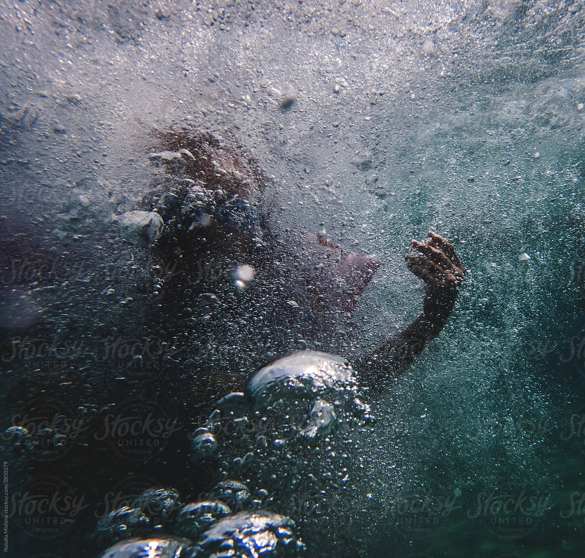 Dive under water.