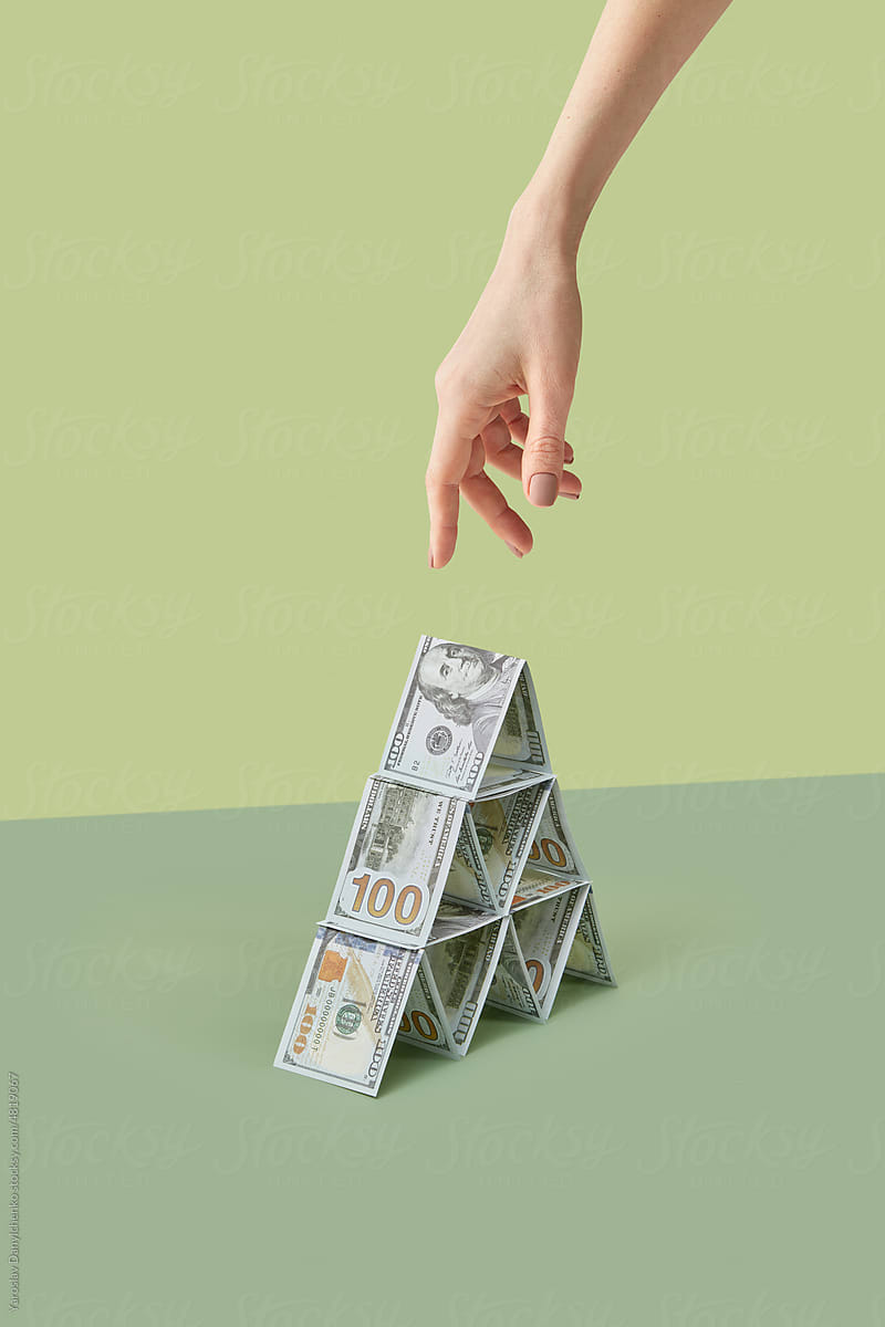 Dollars in pyramid shape with hand reaching out.