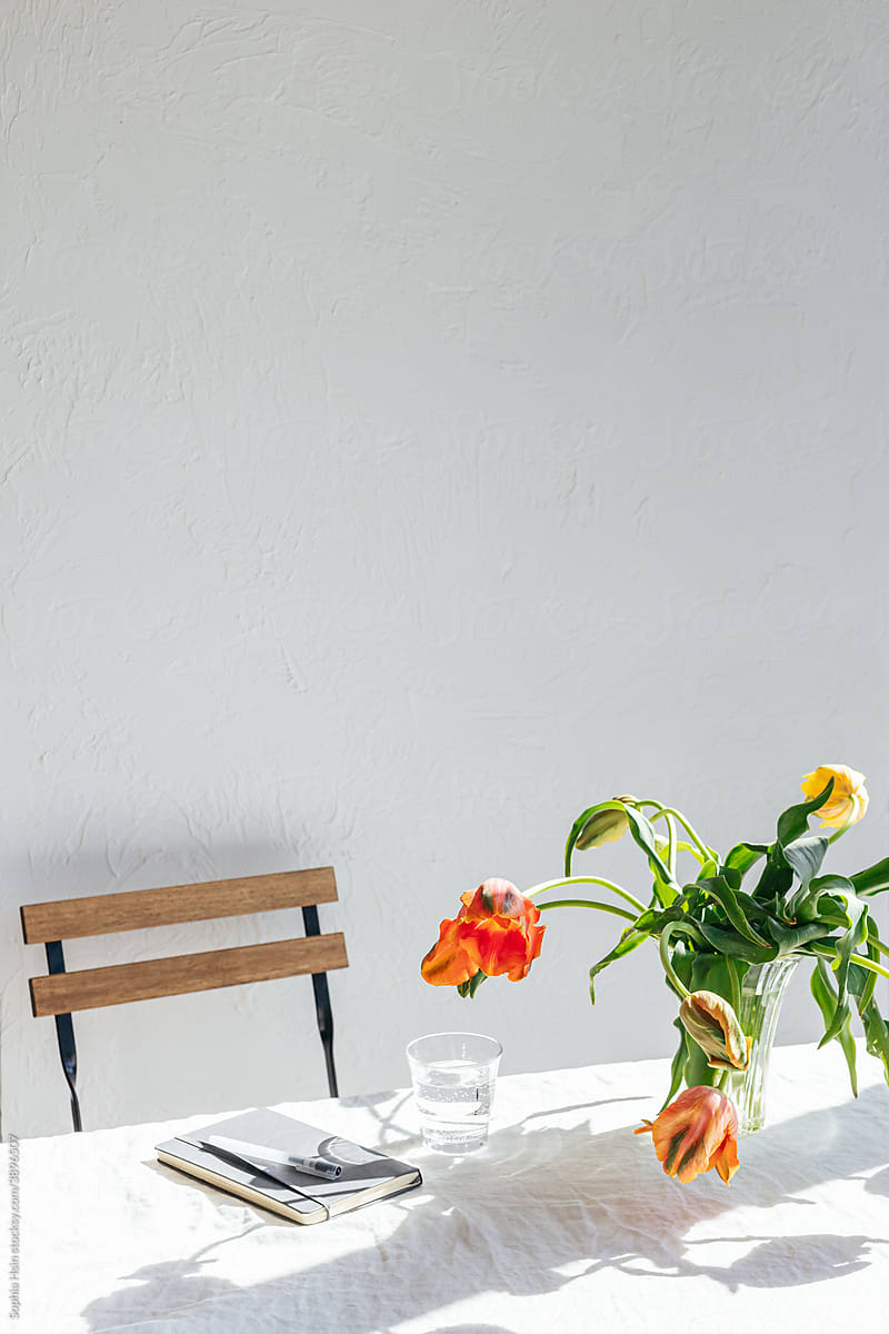 Writing desk with chair, table and flowers