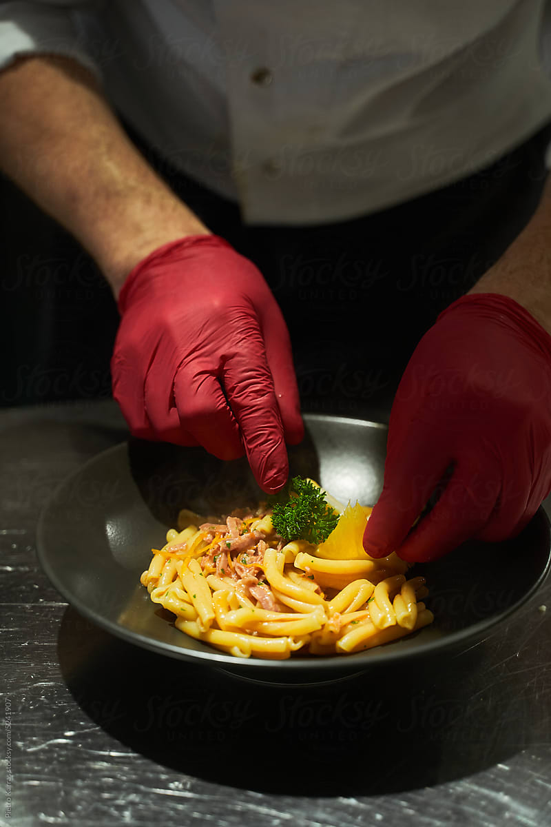 Chef making pasta dish in restaurant