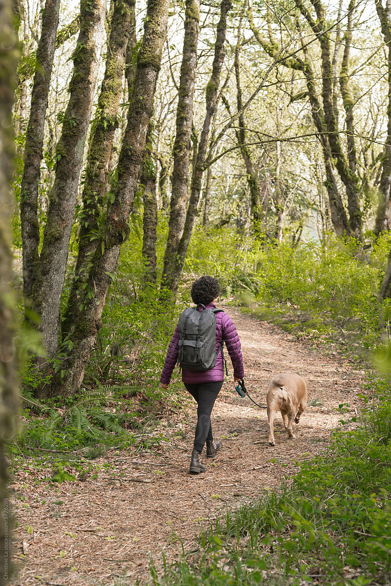 Woman walking her dog in nature