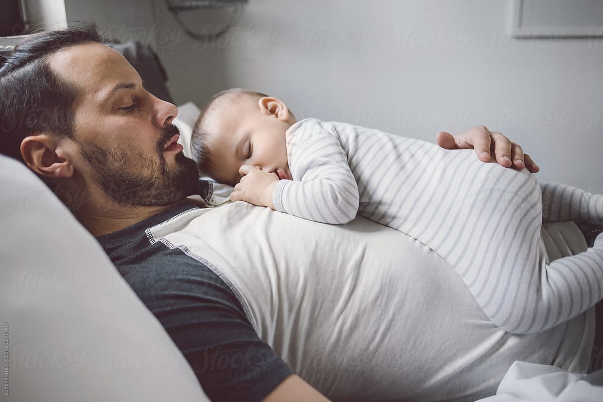 "Baby Sleeping On Father's Chest" by Stocksy Contributor "Lumina" Stocksy
