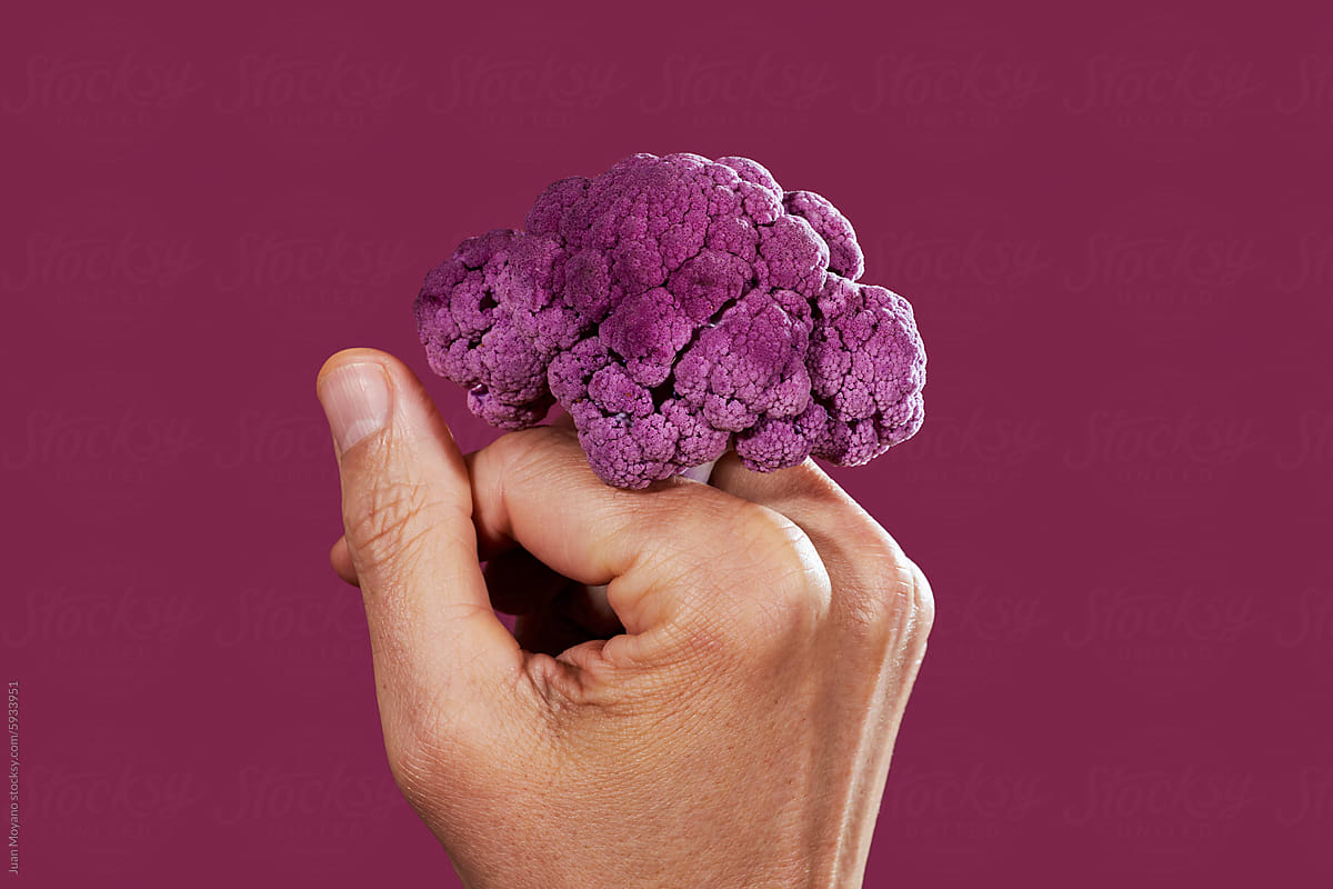 man with a piece of purple cauliflower