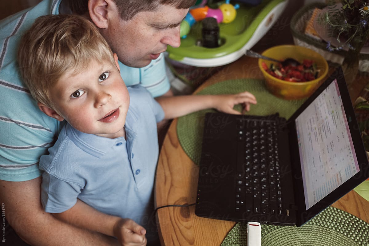 Father with kid child son family at home use laptop