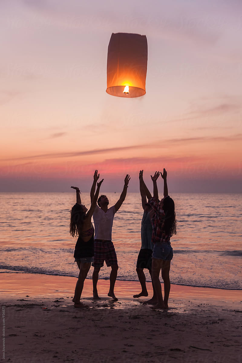 Friends Releasing A Lantern At The Beach In Thailand By Jovo Jovanovic 