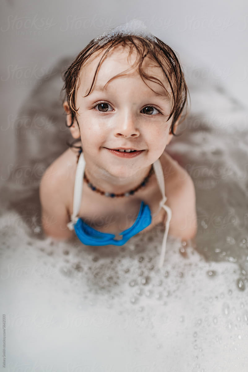 Toddler Enjoying A Bubble Bath At Home by Stocksy Contributor