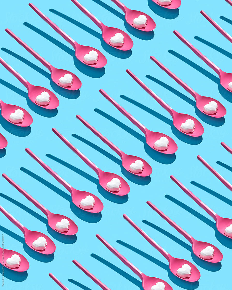 Plastic pink disposable spoons pattern with hearts.
