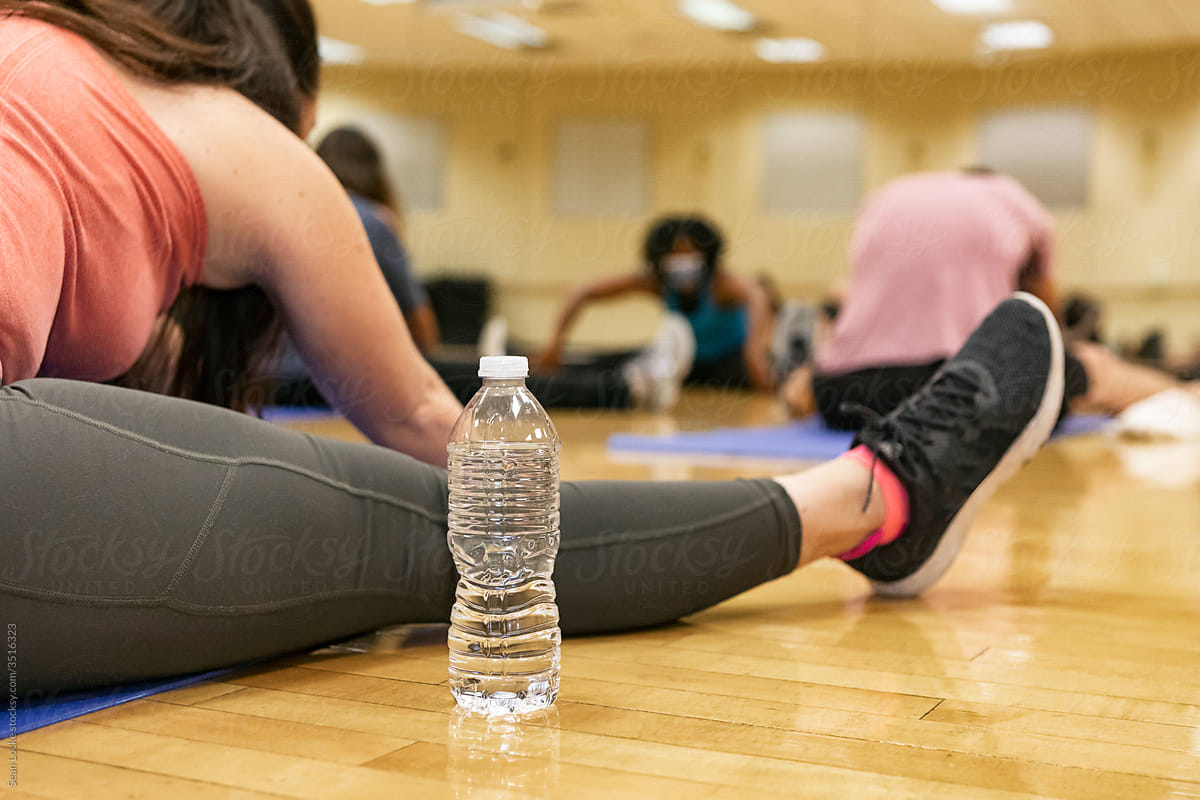 Gym: Focus On Water Bottle During Stretch Class