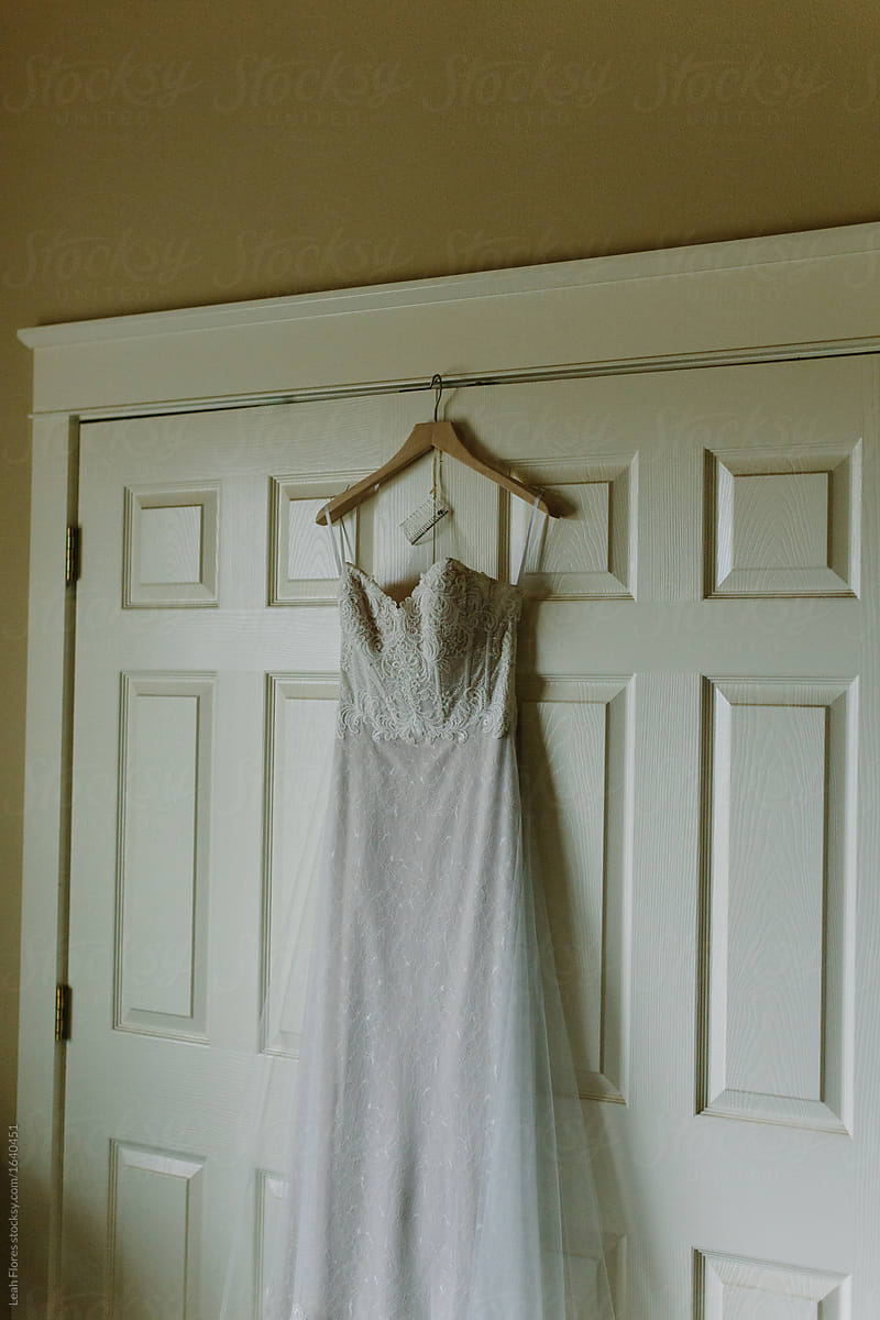 Beautiful Wedding Dress Hanging on Closet
