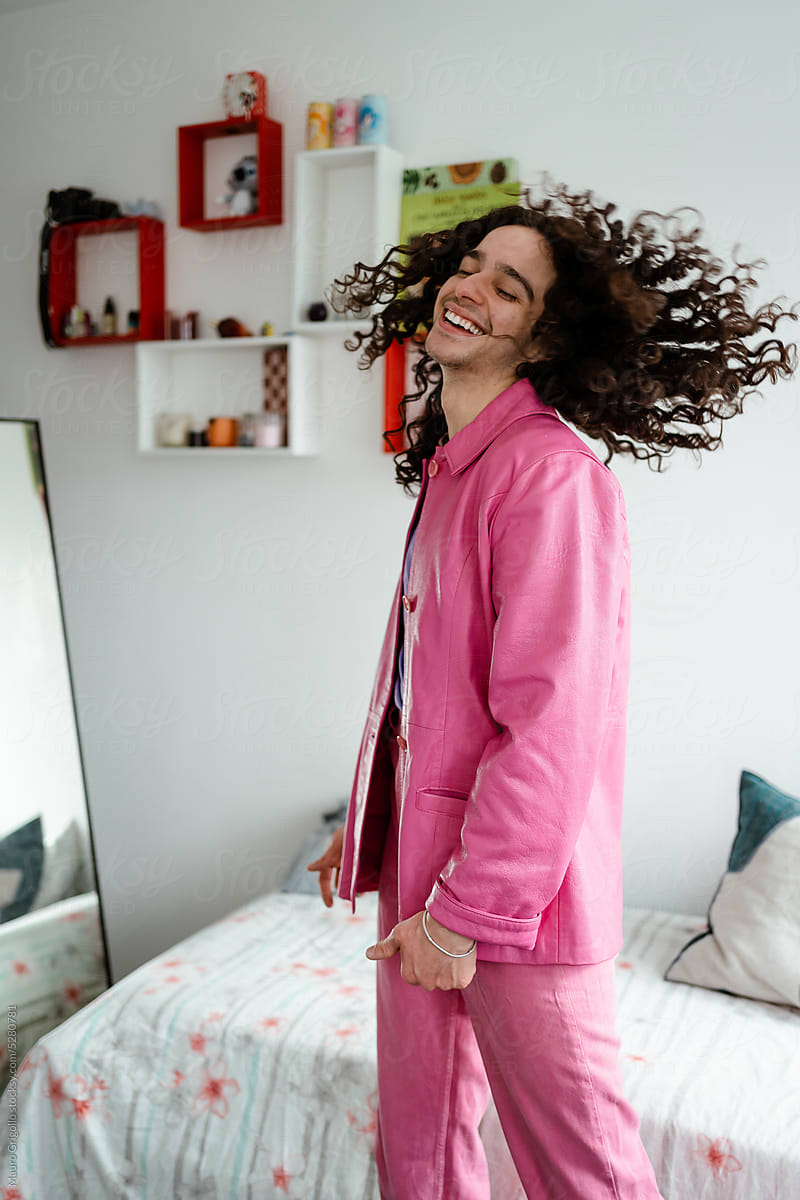 Happy man in pink clothes have fun indoors