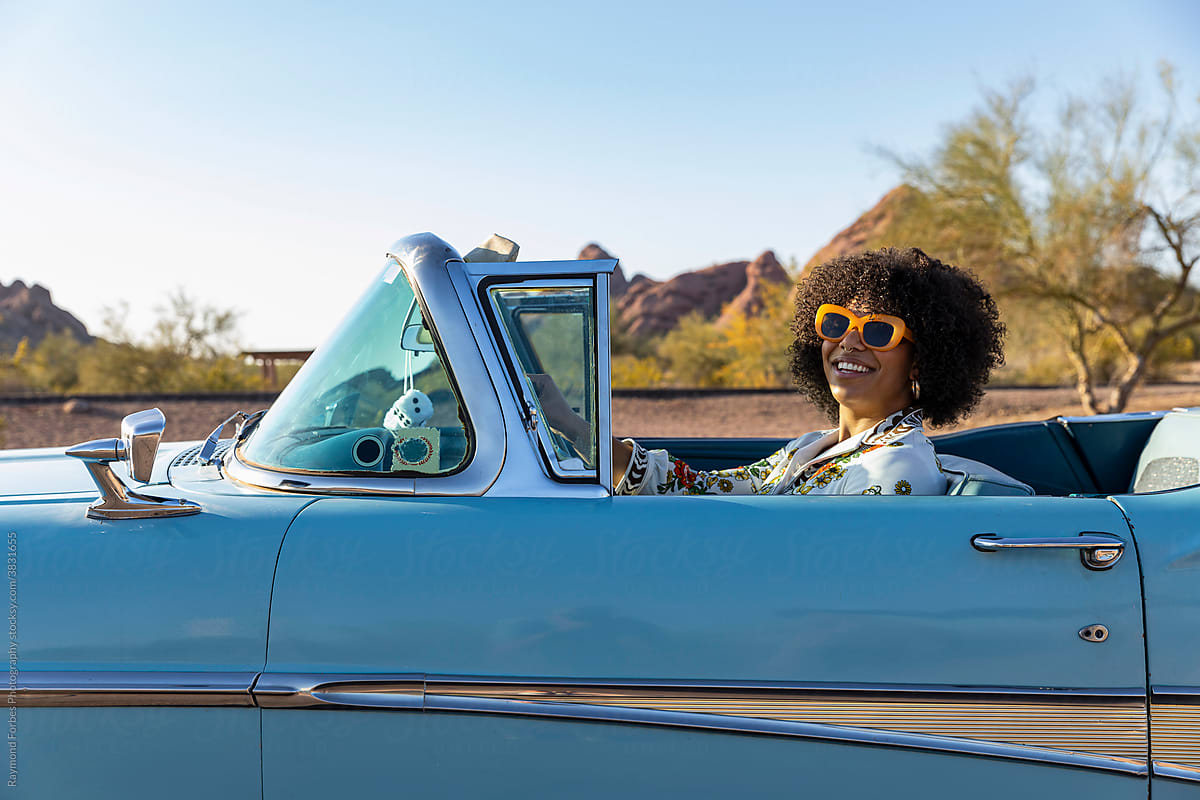 Stylish Black woman in vintage car