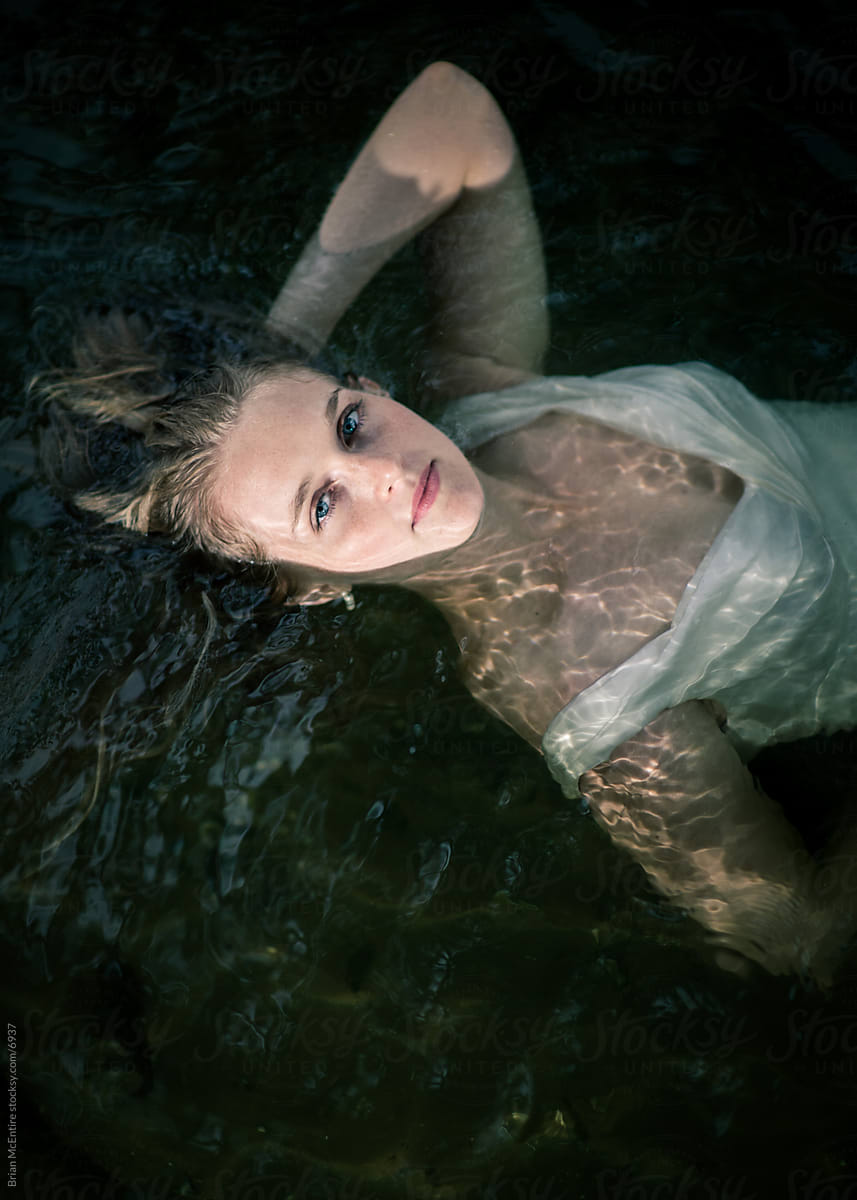 Woman\'s Trash The Dress Portrait in Running Water