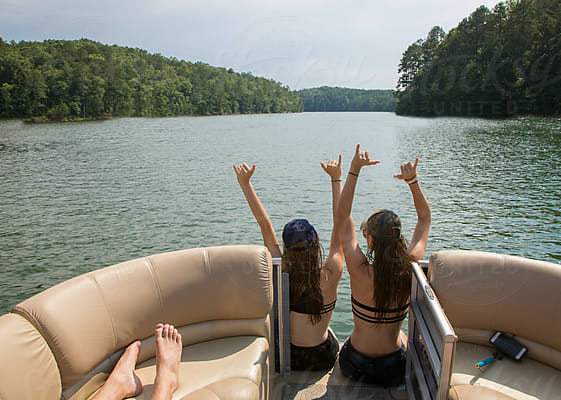 Teenage Boy Standing On A Dock In Cargo Shorts And Cowboy Boots by Stocksy  Contributor Carolyn Lagattuta - Stocksy