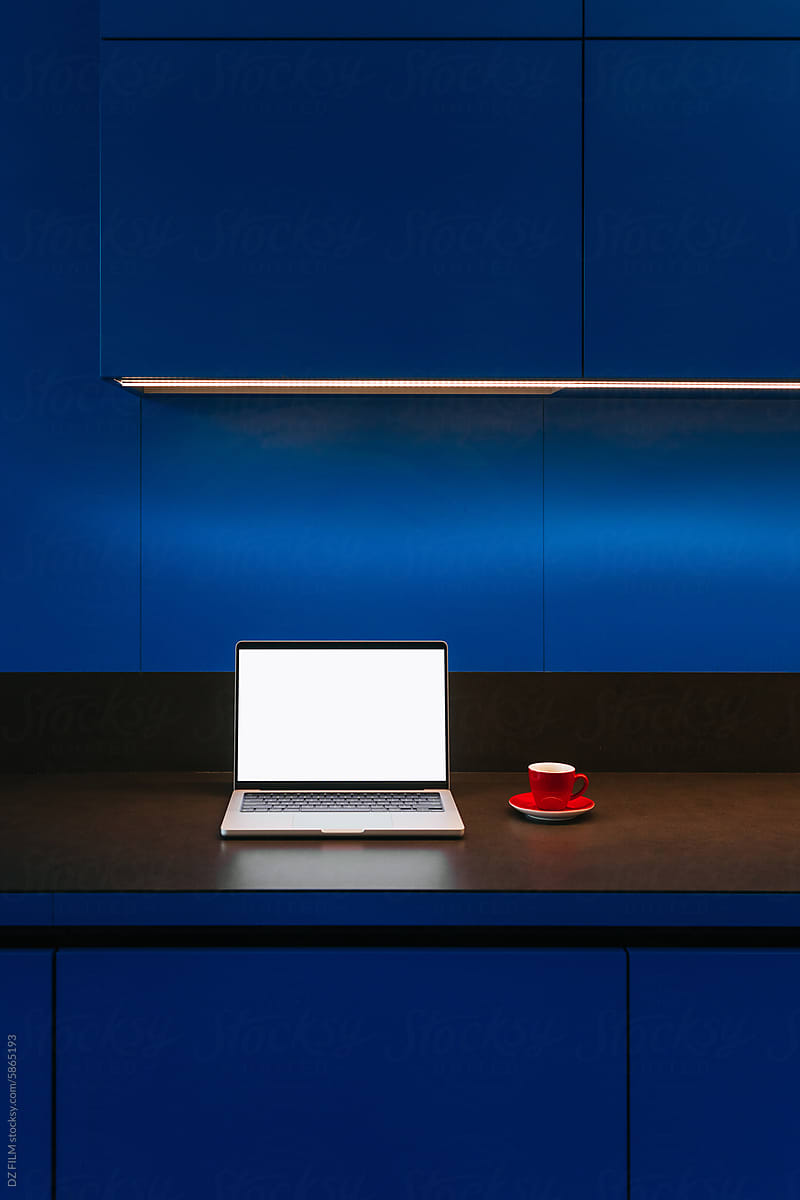 A laptop with white screen in the kitchen