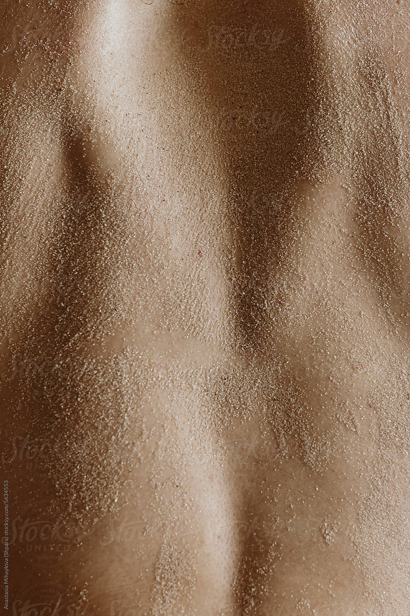 Detail-Close up photo woman's skin texture of woman's back in the sand