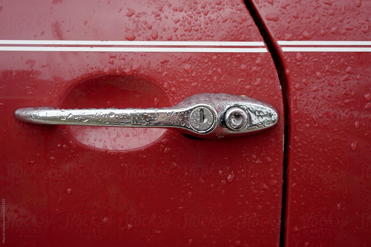 Details of vintage red car in the rain