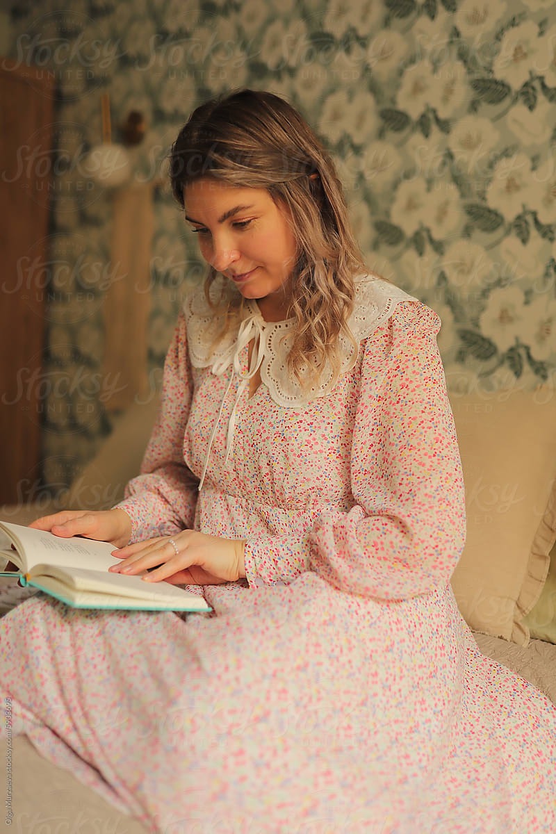 a woman in a pink dress  reading book i