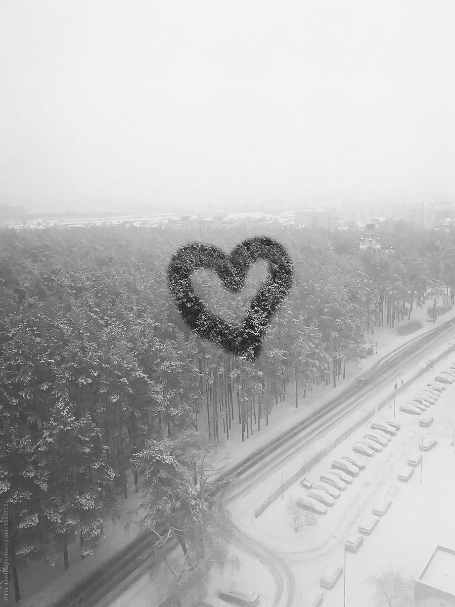 Heart on glass in winter day