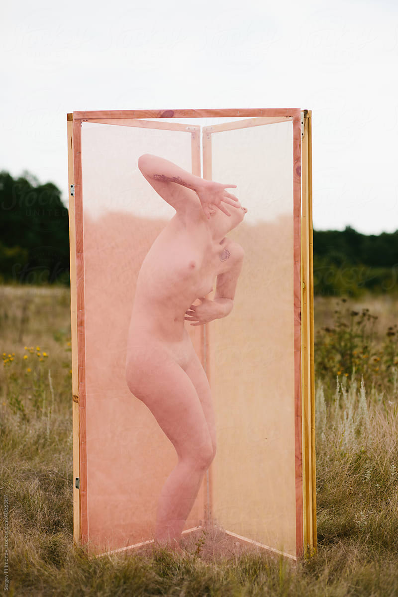 Naked woman dancing in pink box