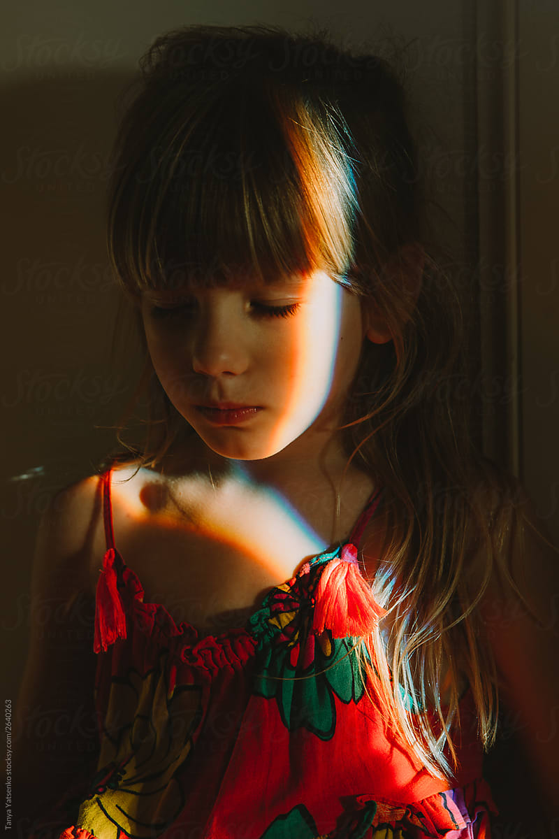 Portrait of a girl with ray of light on her face
