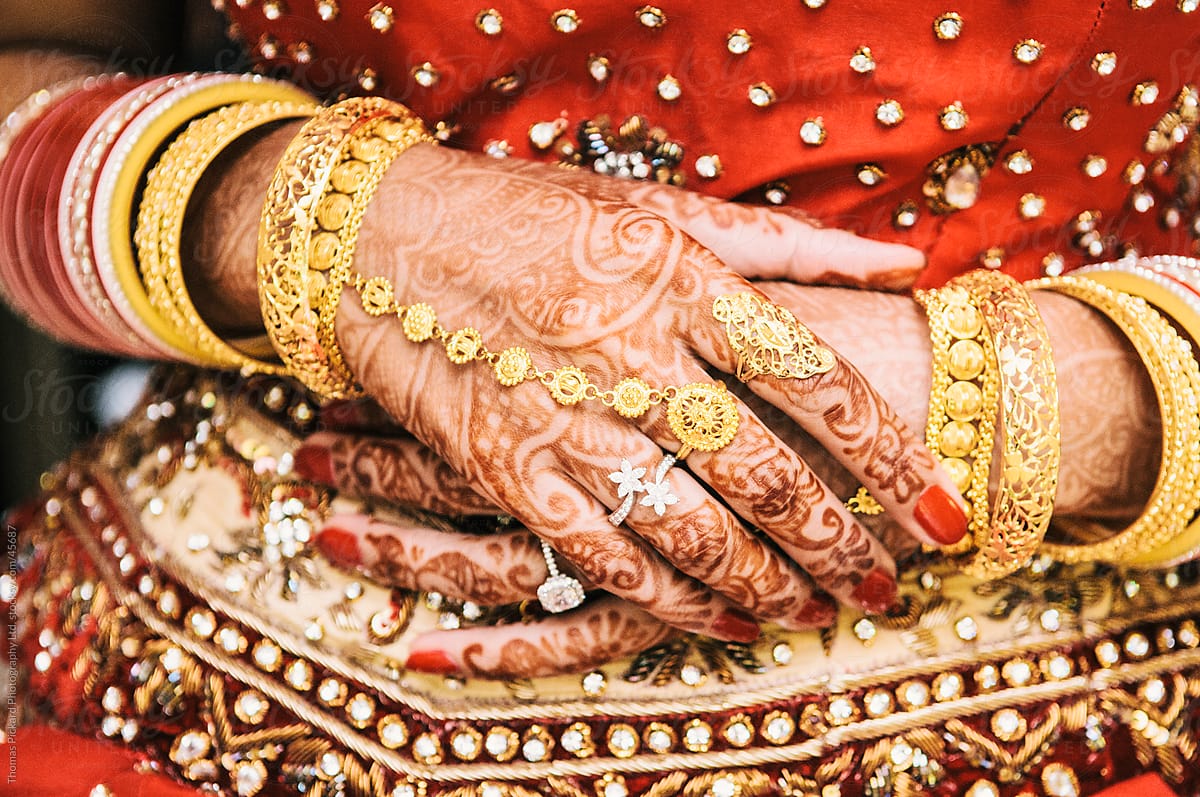 Woman\'s hands painted with henna at an Indian wedding.