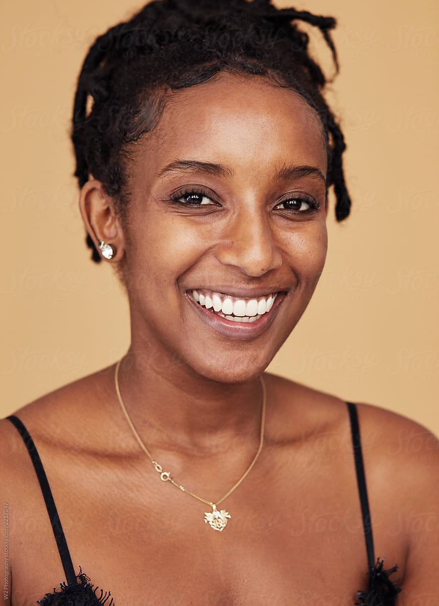 Smiling joyful portrait of a young black woman.