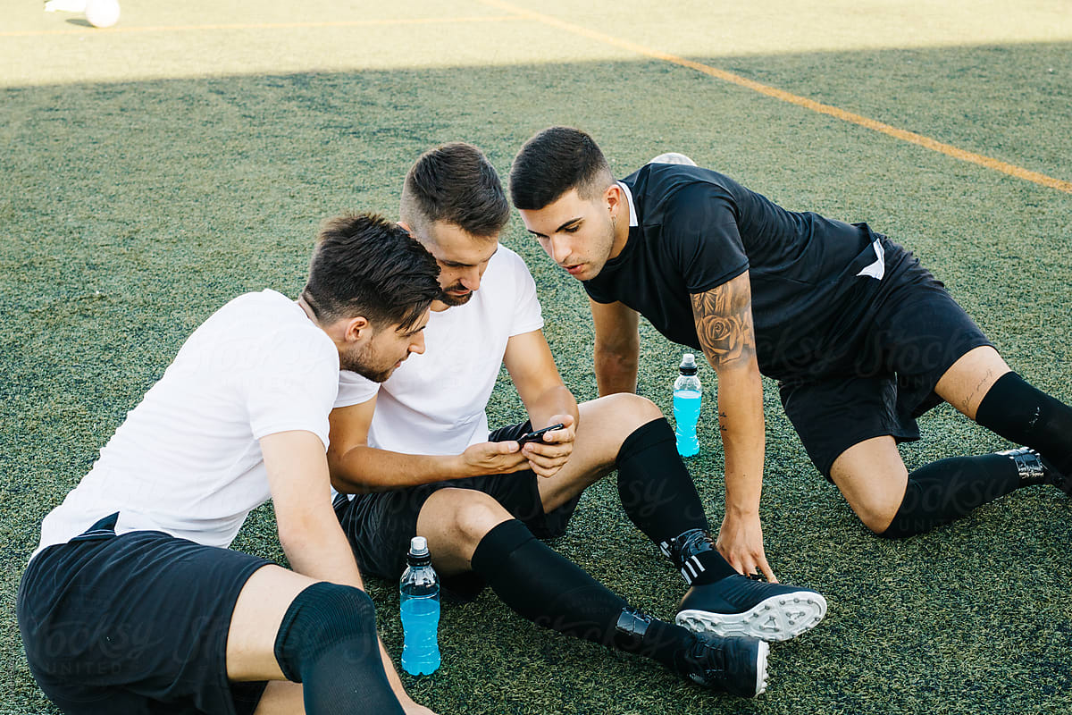 Soccer players looking phone
