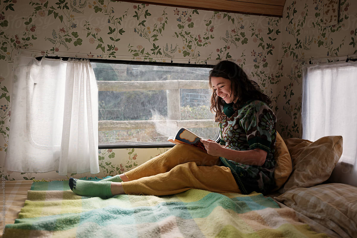 woman reading a book in camper van