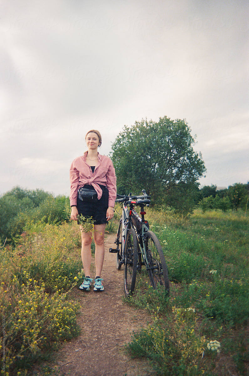 Woman with bike in countryside