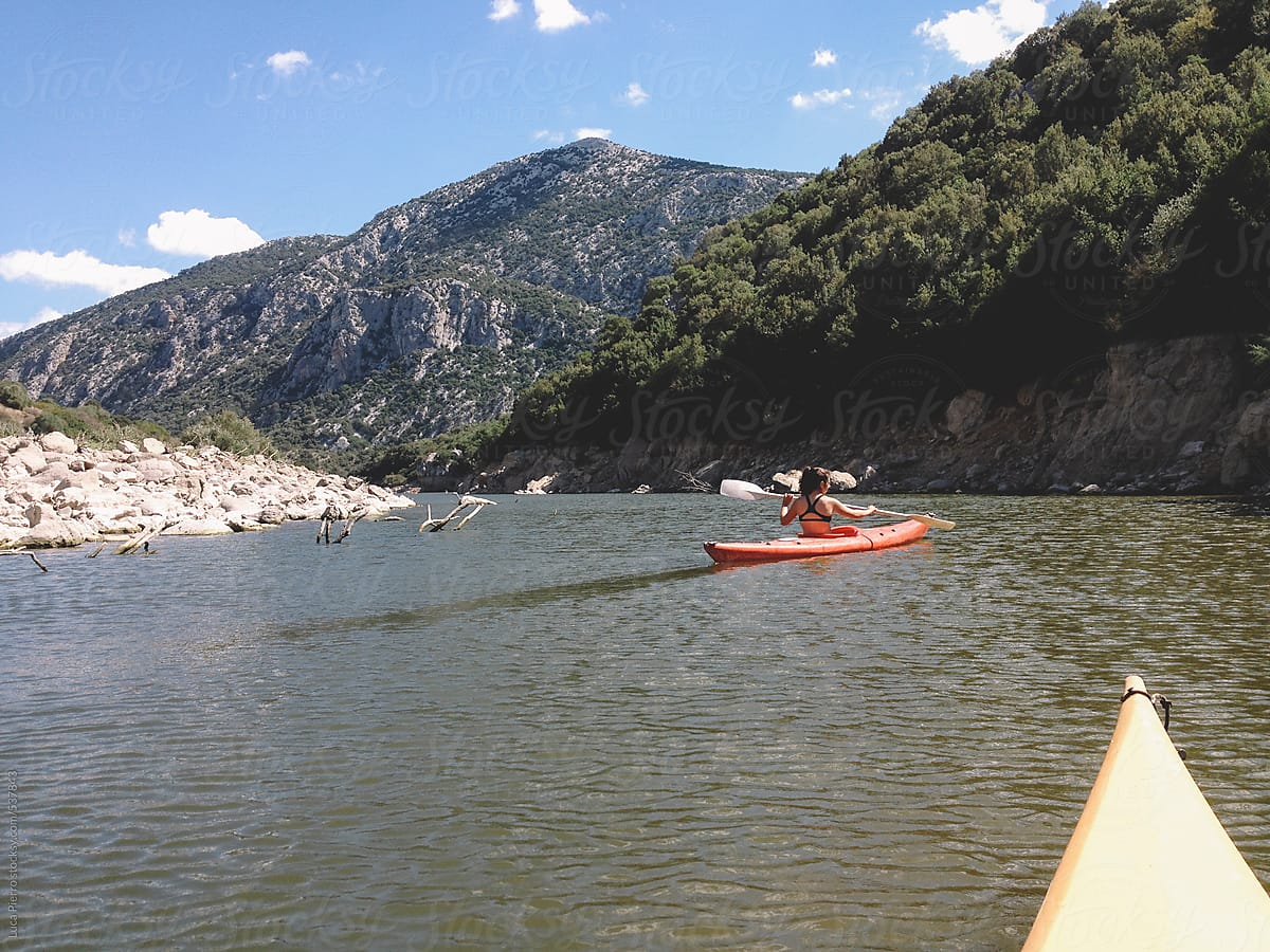 Woman kayaking in Cedrino lake, Sardinia, Italy