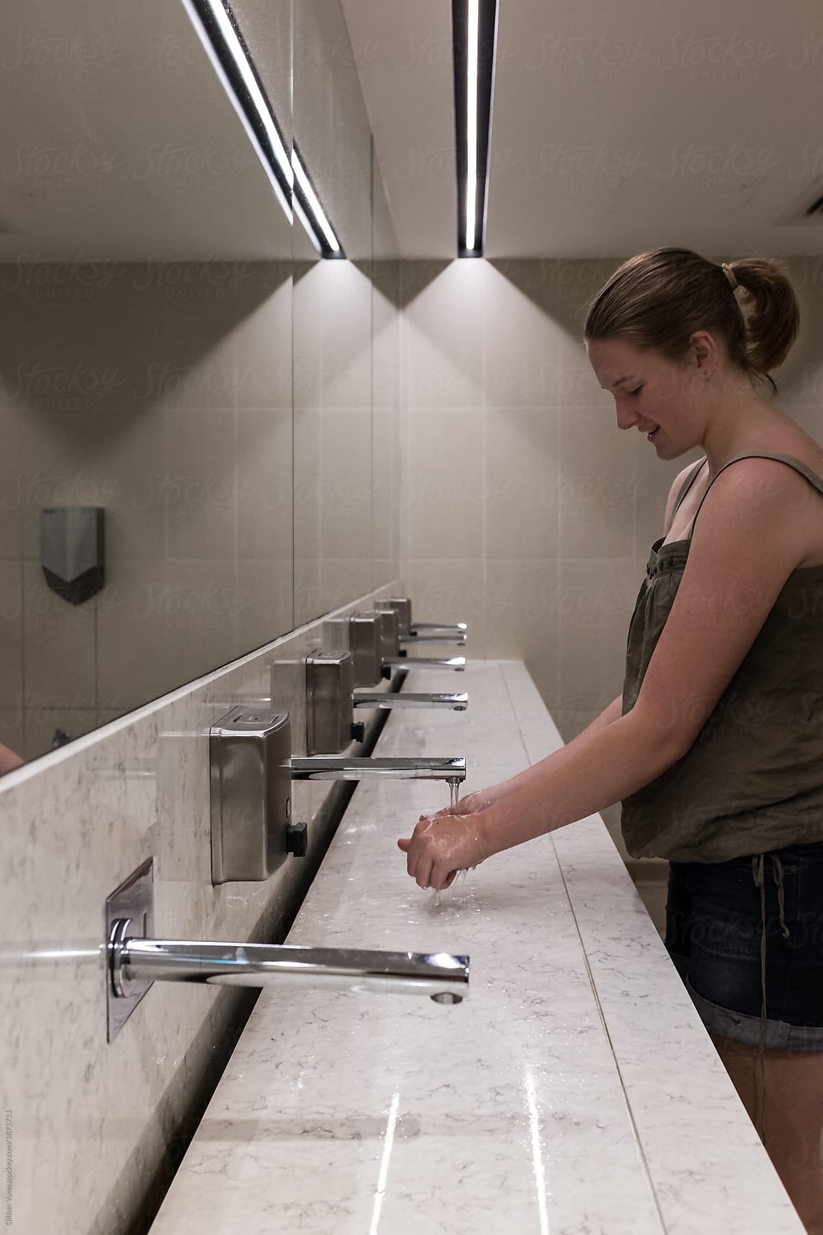 Teen Washing Her Hands In Basin In Public Toilets By Gi