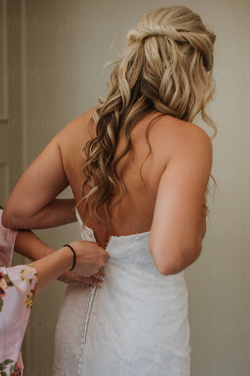 Wedding Dress Being Zipped up on Bride