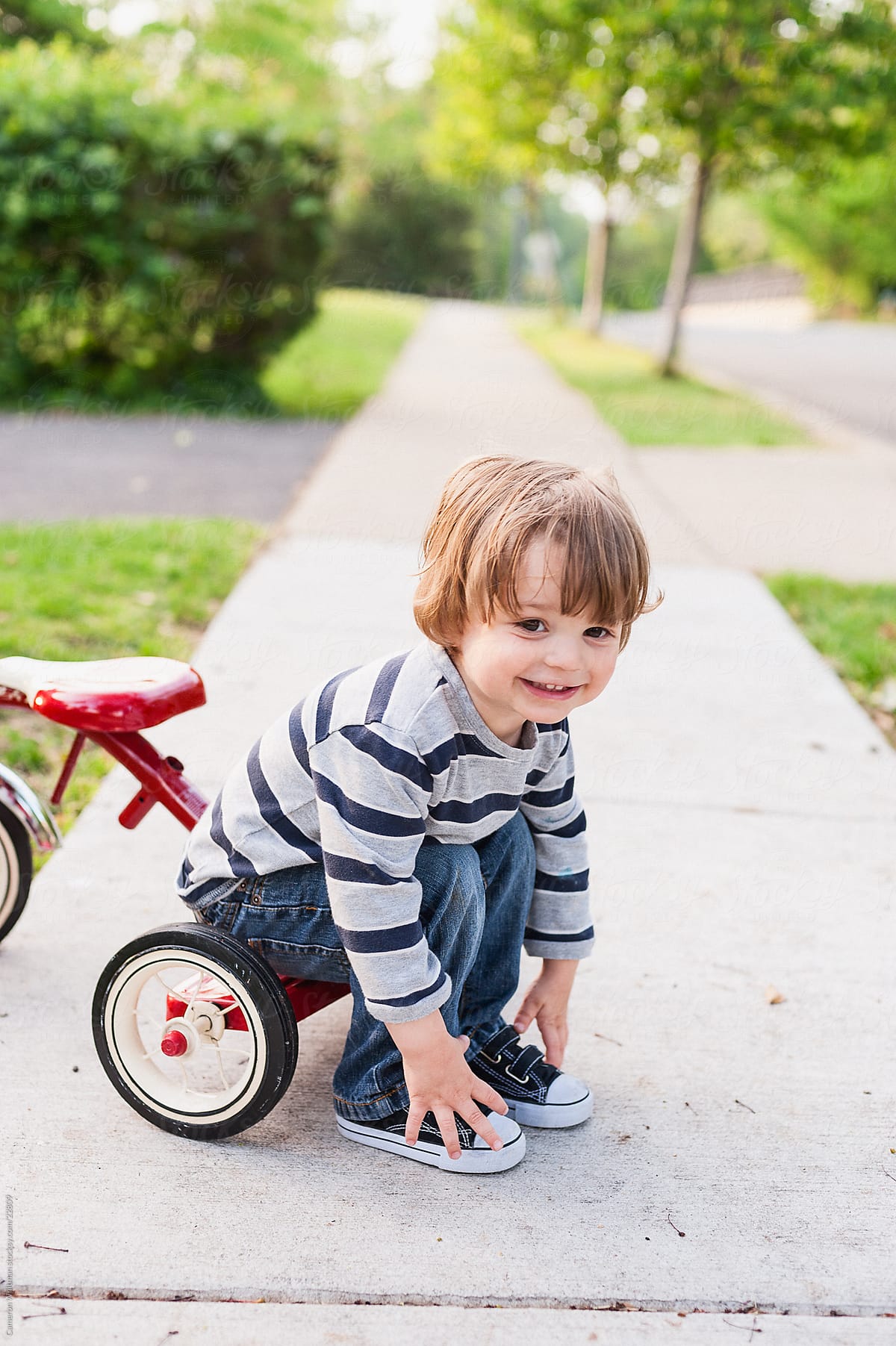 "A Boy And His First Tricycle" by Stocksy Contributor "CWP, LLC" - Stocksy