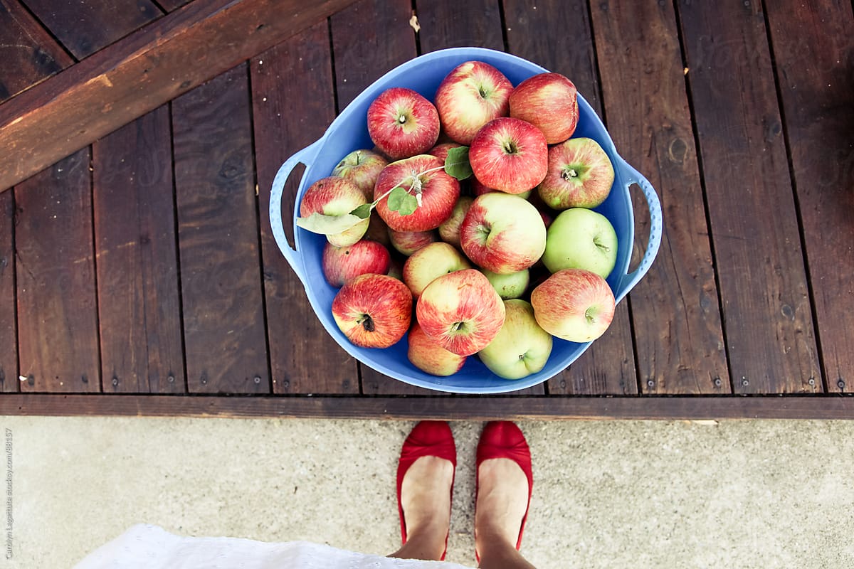 A girl in red flats with her apple bounty