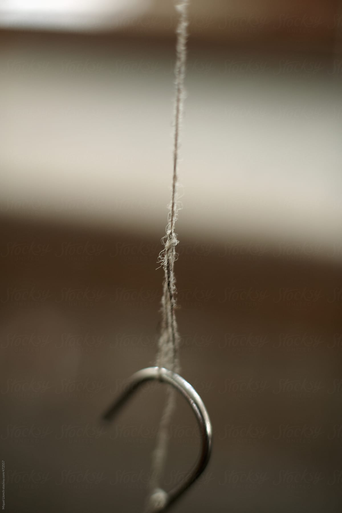 Close up of a thin thread in a textile workshop