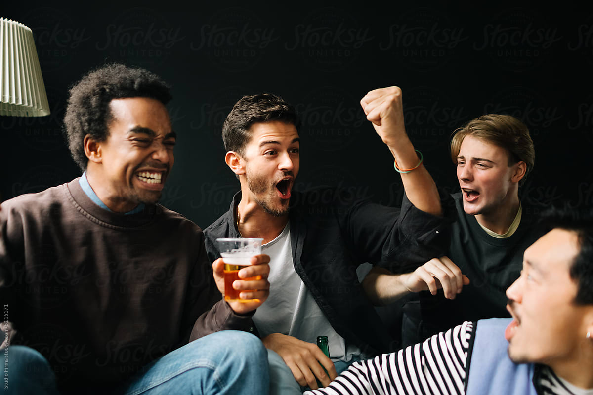 Young Men Watching Match at Home