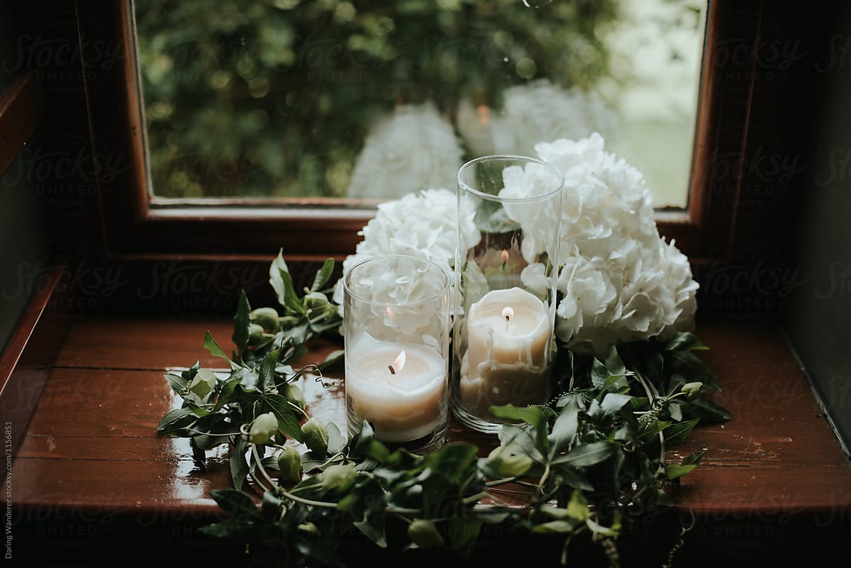 Romantic greenery vines and candles in front of window for elegant wedding